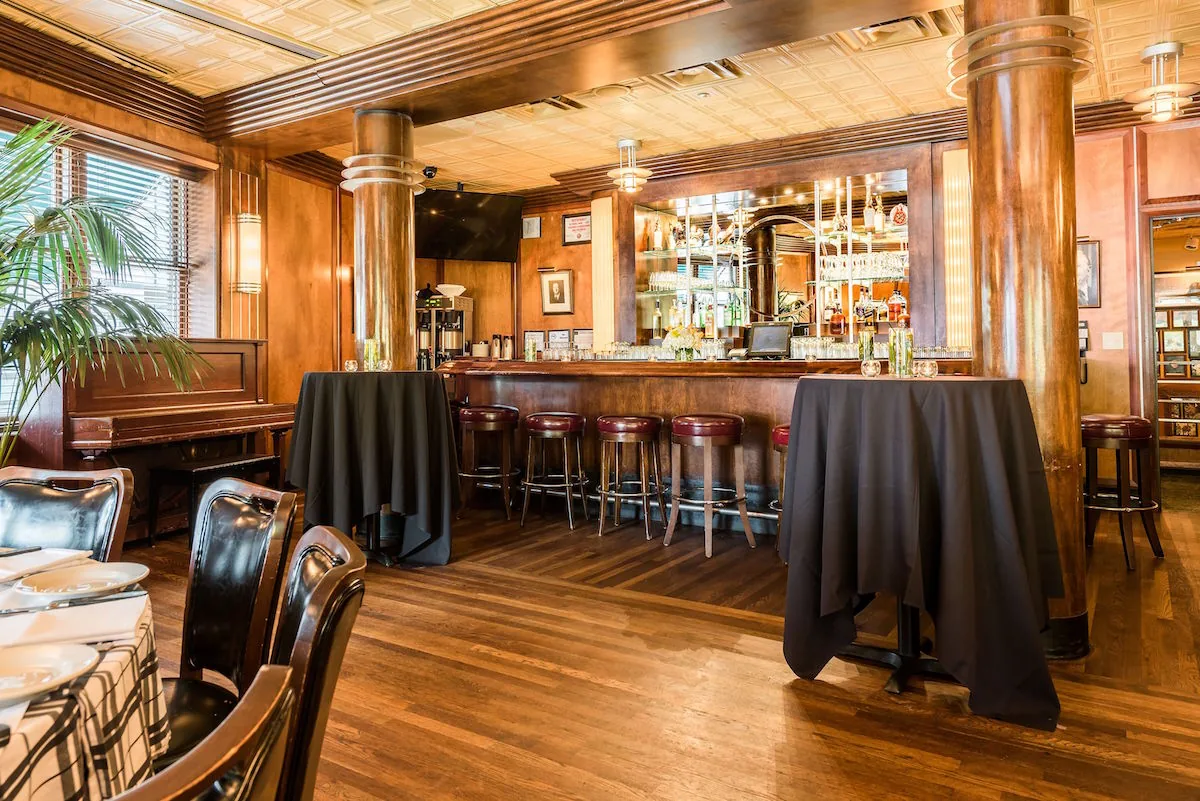 Gibsons Bar & Steakhouse - wood bar tin ceiling
